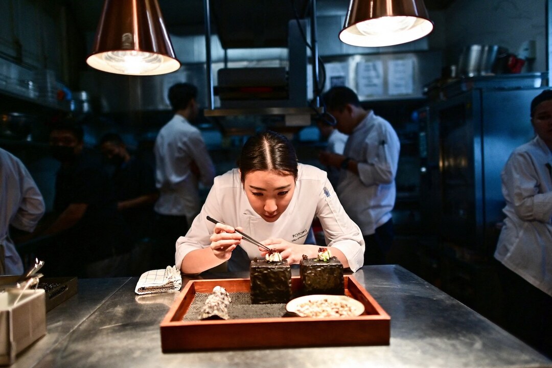 A chef prepares a dish in the kitchen before it is served. (File/AFP)